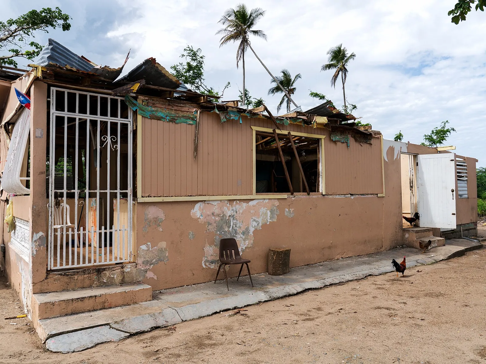 Casa de cemento con rejas y techo dañado en Loíza, Puerto Rico